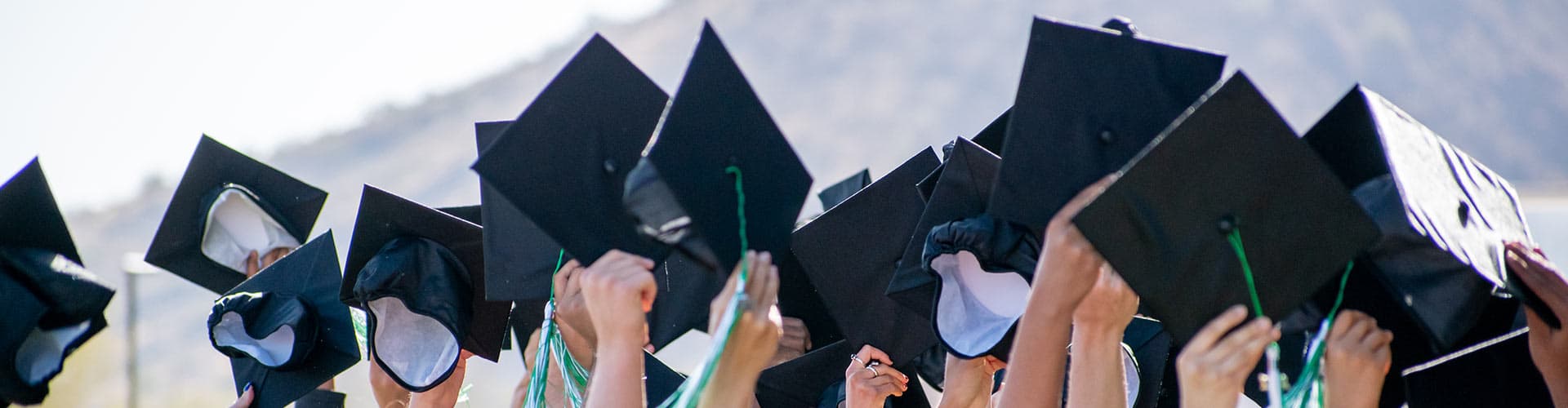 Graduation caps raised in the air